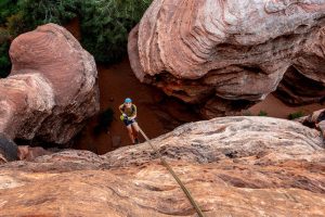 A Rock Odysseys guest enjoying a scenic rappel during a half-day canyoneering adventure.