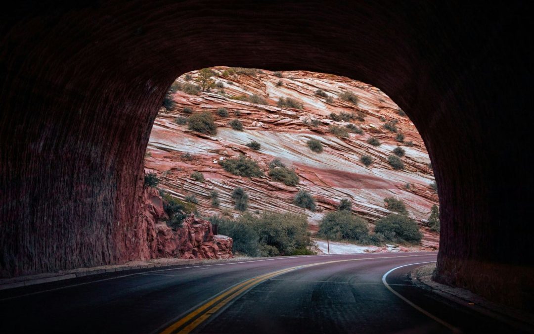 The historic west entrance of the 1.1-mile Zion-Mt. Carmel Tunnel in Zion National Park, showing the stone masonry facade.