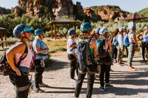 A corporate team after putting on harnesses and helmets with a Rock Odysseys guide in Southern Utah.